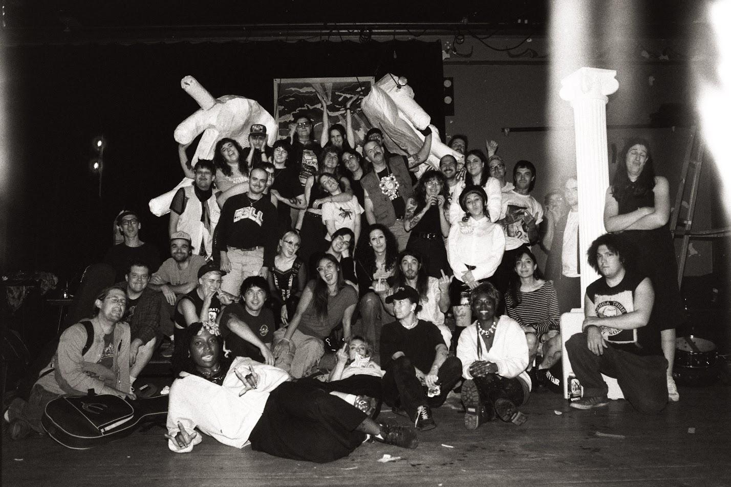 The performers, organizers, and attendees gather for a group photo at La Sala Rossa